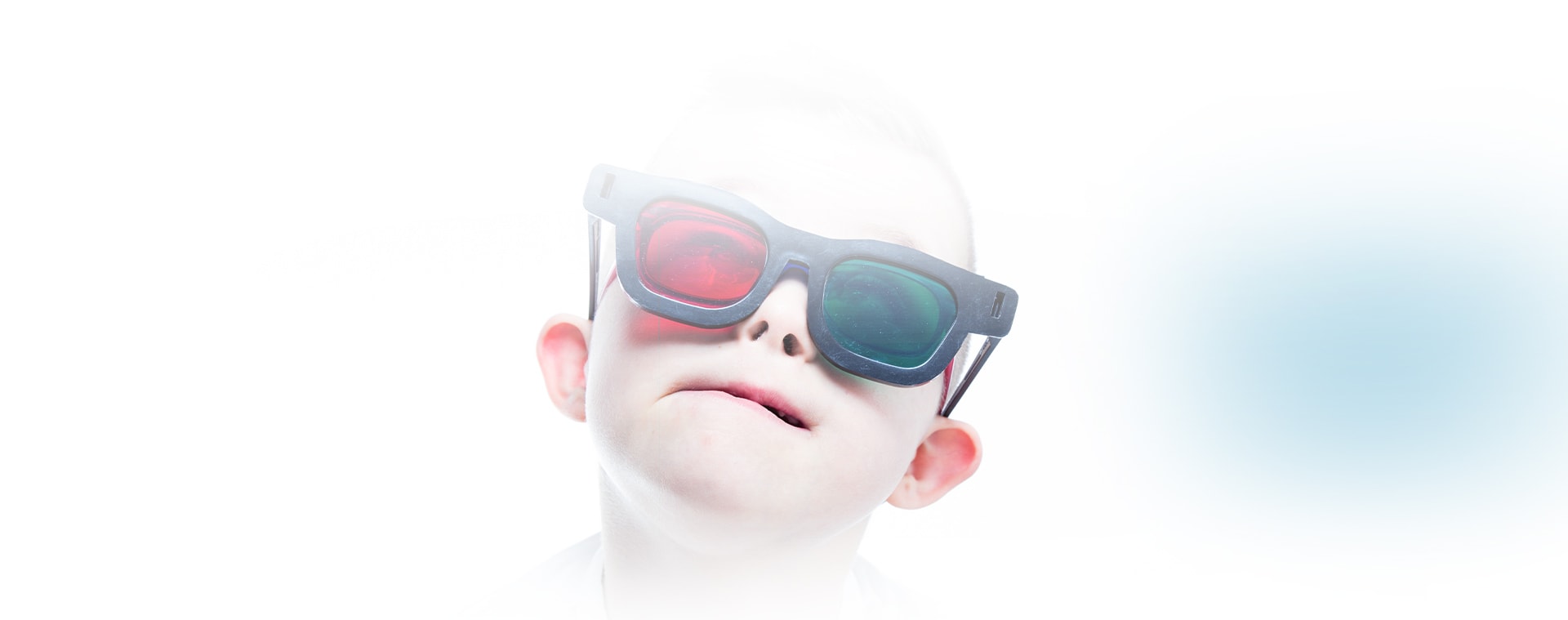 Child with coloured glasses getting eye exam