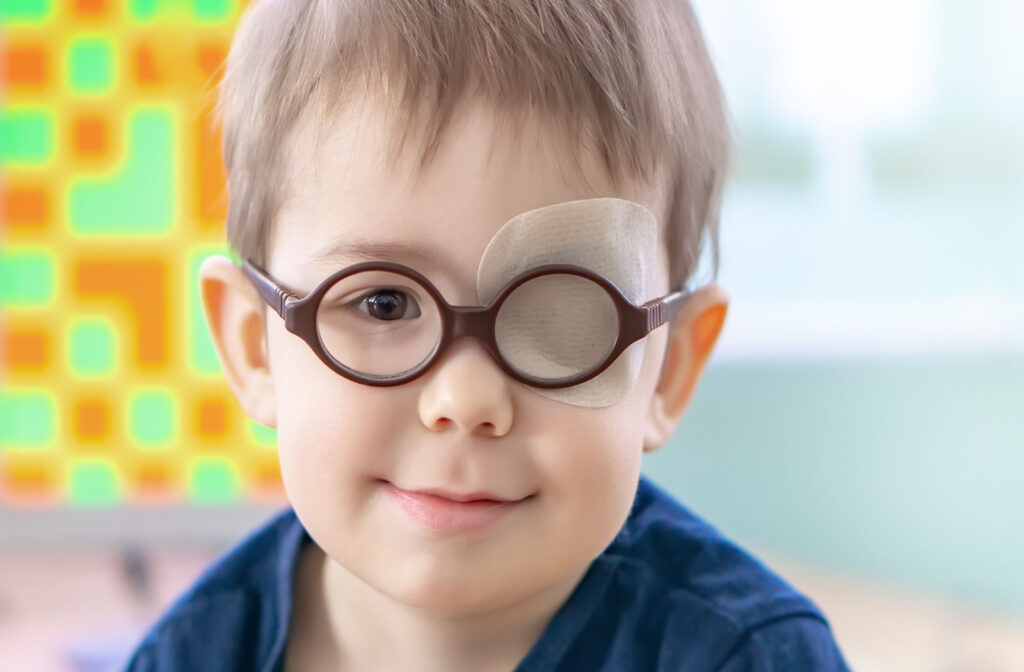 A little boy wearing glasses and an eye patch occluder.