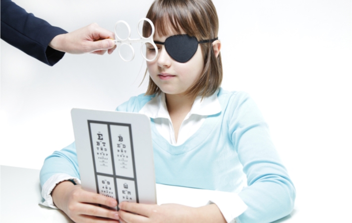 A young female patient practices with prism flippers.