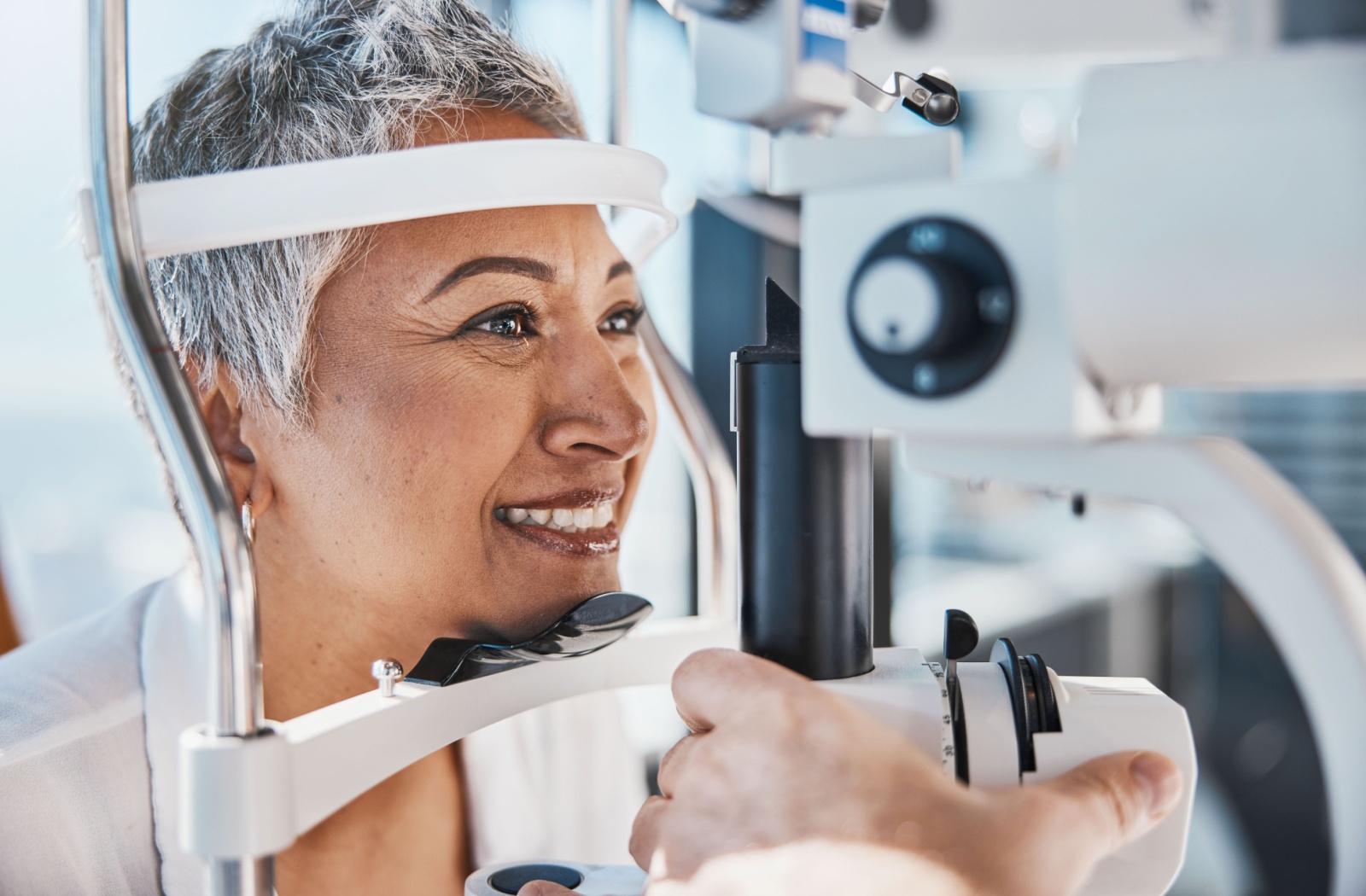 Happy older woman getting an eye exam