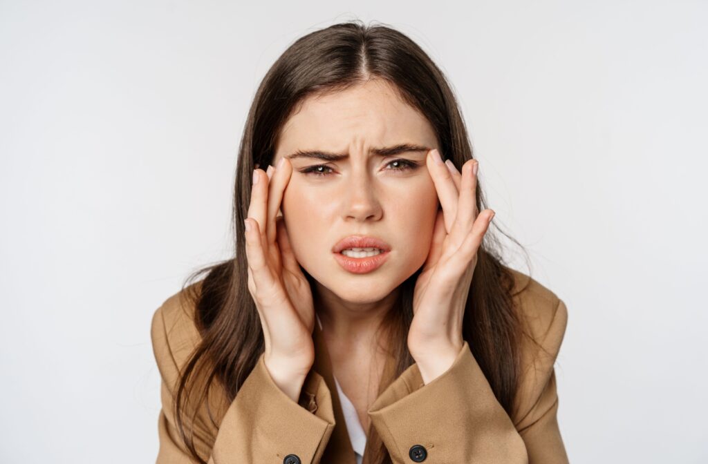 A patient squints and strains their eyes due to unaddressed refractive errors that lead to poor eyesight.